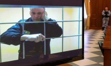 Alexei Navalny is seen on a screen via a video link in court