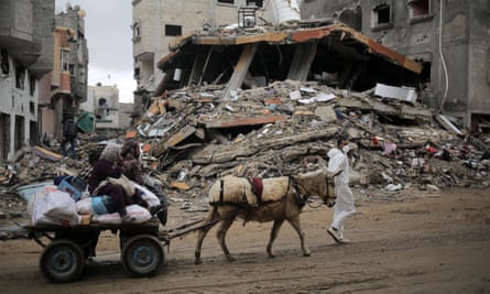 Palestinians transport their belongings on a donkey-pulled cart as they flee Khan Younis