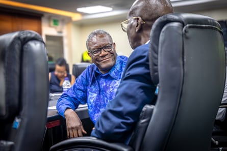 Denis Mukwege smiles as he listens to Dr Mohamed Janabi.