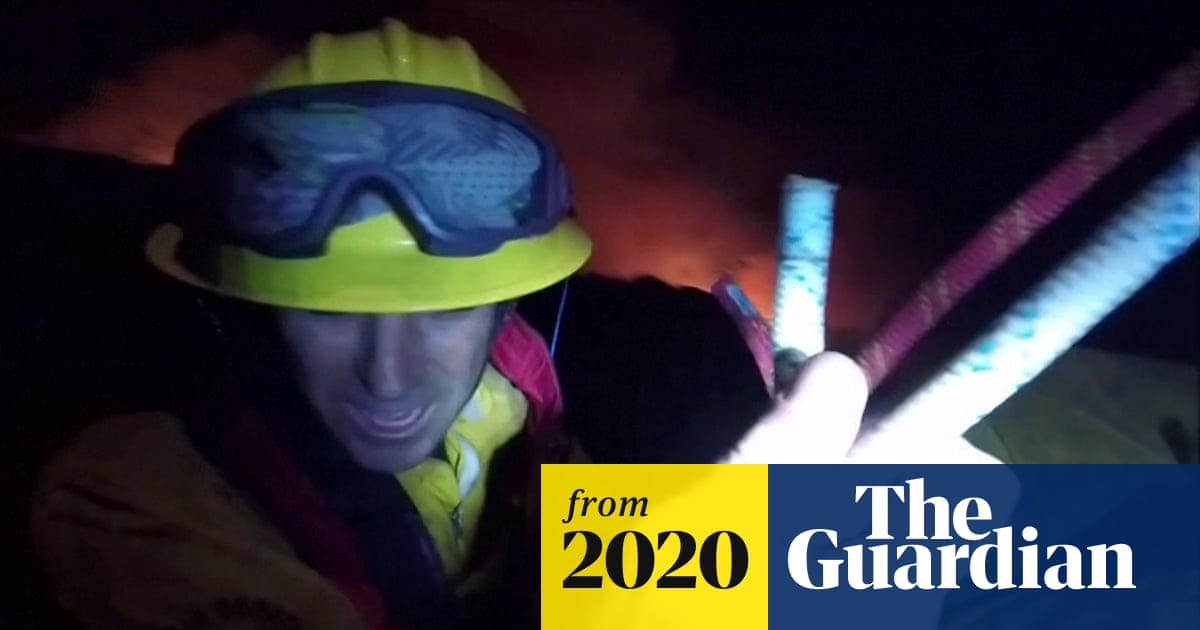 California wildfires: helicopter rescues firefighters as blaze advances – video