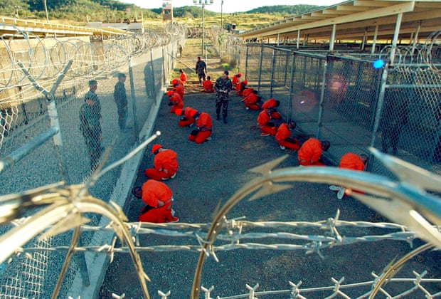 Detainees sit in a holding area in Guantanamo Bay. Trump has vowed to expand the prison.