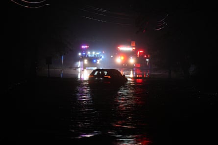 a car drives on a flooded street