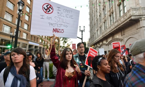 Larissa Roberts holds up a sign as protesters gather to march against racism in Oakland, California in August
