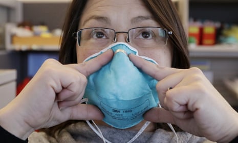 Eileen Benoliel, a Seattle and King county public health nurse, deomonstrates how to properly fit a mask. 