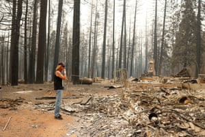 Fred Batten looks at debris after the Caldor Fire overran the El Dorado county town of Grizzly Flats.