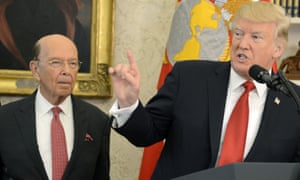 Commerce secretary Wilbur Ross listens to Donald Trump speak.