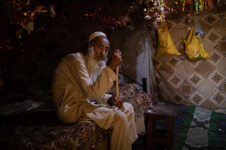Shah Mast, 90, sits at his home in a cave