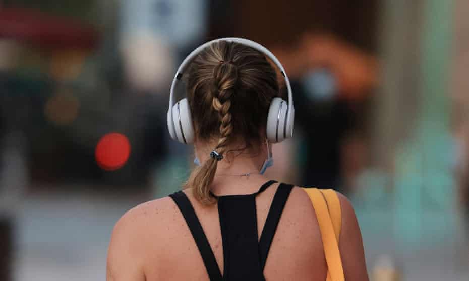Back of woman's head with headphones on