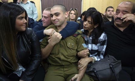 Elor Azaria sitting with his parents and his girlfriend Orel (left) as he awaited the verdict at the military court in Tel Aviv on Wednesday.
