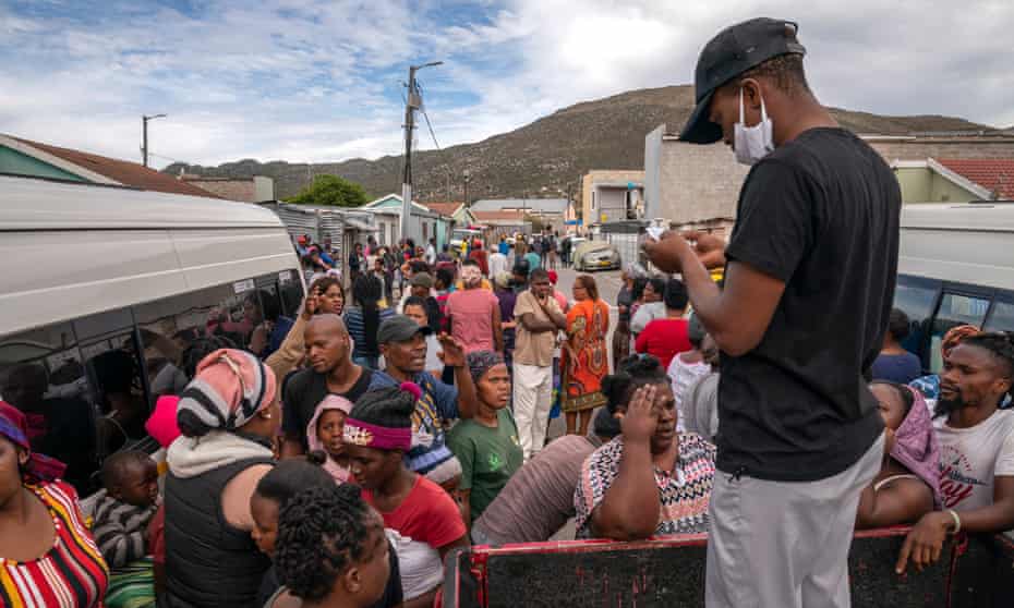 An aid worker delivers food parcels to vulnerable families near Cape Town, South Africa.