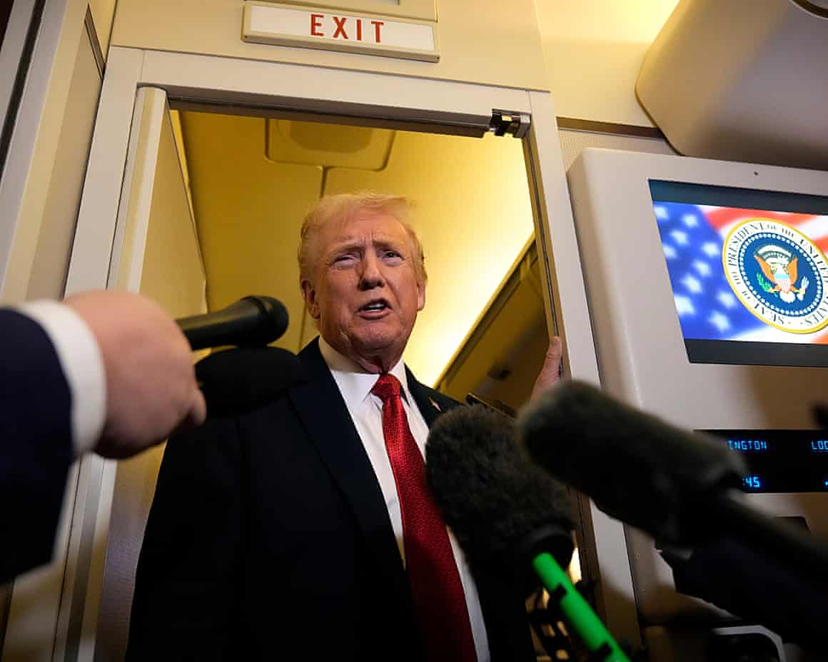 Donald Trump speaks to reporters aboard Air Force One