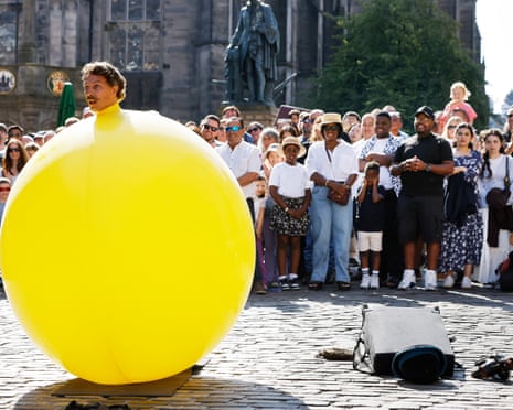 An Edinburgh fringe performer appears in a large yellow balloon