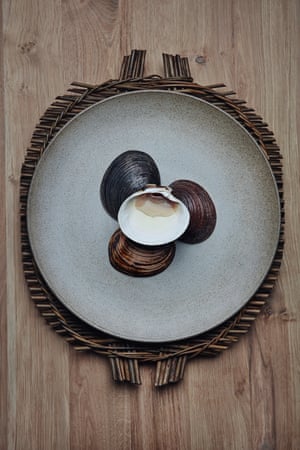 Dish of mahogany clams with preserved tomato water at Under.