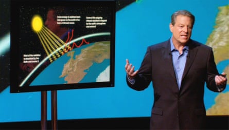 A man in front of a screen depicting the earth.