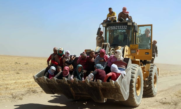 Kurdish peshmerga forces rescue Yazidis after they were trapped on Mount Sinjar.
