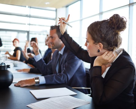 A group of people in formal suits at a table