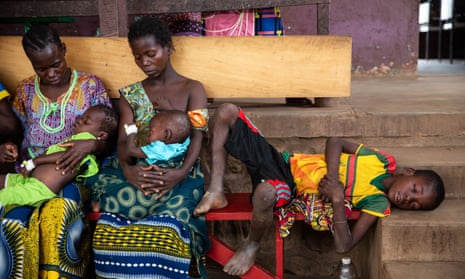 A child with measles awaits treatment with his family at a healthcare facility in Central African Republic.