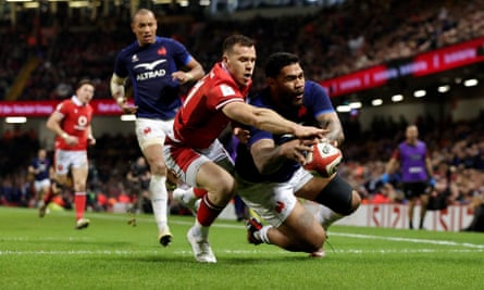 Romain Taofifénua (right) scores France’s fourth try while under pressure from Gareth Davies