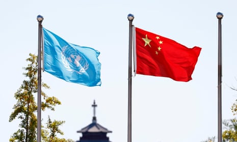 The UN and Chinese flags