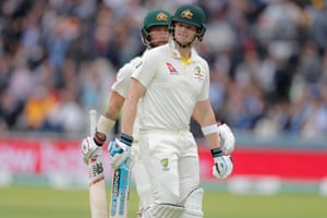Steve Smith (right) and Matthew Wade of Australia leave the pitch as the rain stops playing just before noon.