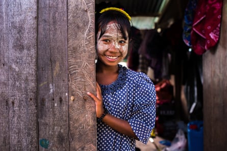 A Bajau girl wearing sunscreen and laughing
