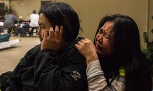 Marie Nickolai sobs while her partner, Steven Moses, tells family members about Isaac’s death.