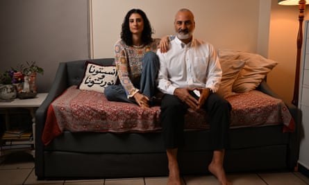 Lamisse and her father, Hazem, sitting on a couch side by side.