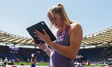 Molly Caudery reviews her qualifying jump on a tablet at the Stadio Olimpico.