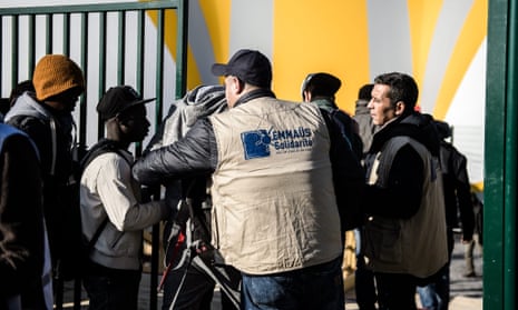 Social workers check migrants from Calais at a new centre at Porte de la Chapelle in Paris, France