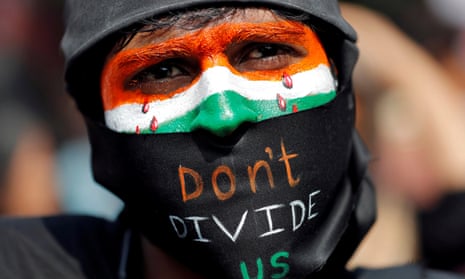 A demonstrator with face painted in Indian flag saying 'don't divide us'