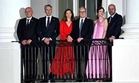 Victoria Starmer, third from left, stands next to her husband, Keir Starmer, on a balcony with other guests