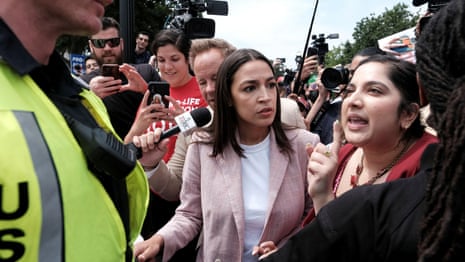 AOC escorted by police as she joins pro-abortion rights protests – video