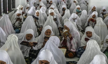 Students from an Islamic boarding school attend a Qur’an recitation during Ramadan in Medan.