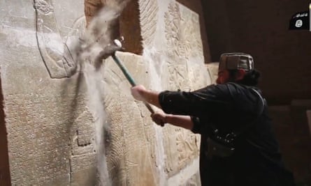 An undated screen grab taken from a video released by the group calling itself the Islamic State (IS) allegedly shows a member destroying parts of a frieze at the ancient Iraqi town of Nimrud, 20 miles southeast of Mosul, Iraq.