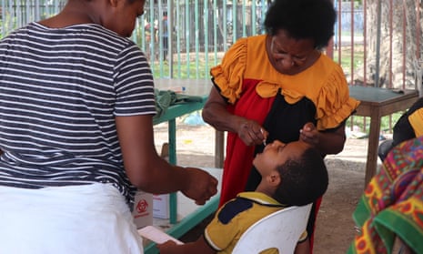Sister Kenegalato Waligia gives polio vaccine drops to Immanual Kyakagn, aged 7, at Gerehu general hospital in Port Moresby, Papua New Guinea.