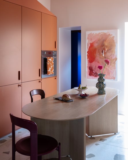 The kitchen’s warm tones and chunky furnishings, complete with a painting by Marine.