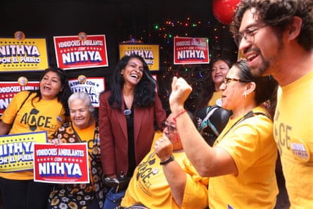 Nithya Raman, center, cheers with supporters.