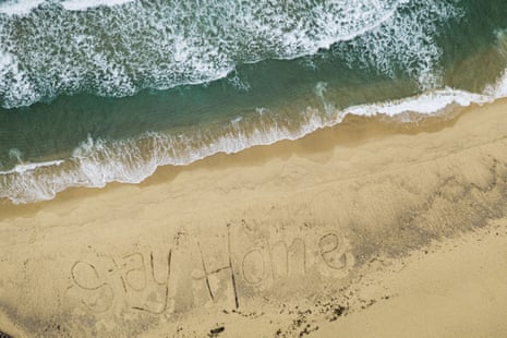 A closed Bronte beach in Sydney with the words #StayHome written into the sand by local lifeguards.
