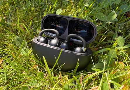 Open earbuds let you tune in without tuning out the world. Here are the five best pairs | headphones Earbuds in case sitting in grass outside