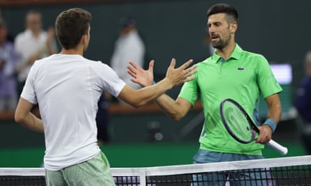 Italy’s Luca Nardi shakes hands with Novak Djokovic after beating him in three sets