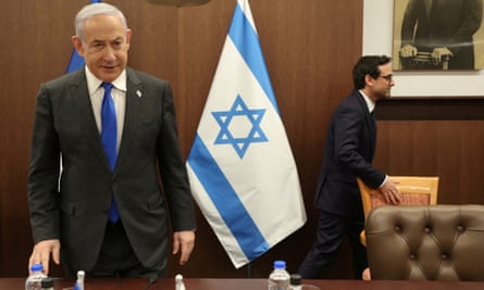 Benjamin Netanyahu stood in front of an Israeli flag