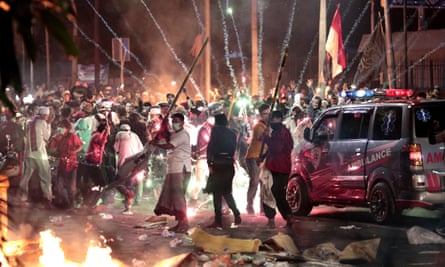 Fire crackers explode near supporters of presidential candidate Prabowo Subianto during clashes with the police in Jakarta on Wednesday