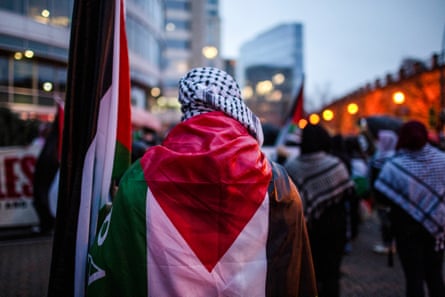 People wear Palestinian flags and keffiyehs in support of Palestinians
