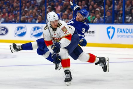 Brandon Hagel of the Tampa Bay Lightning, in blue, collides with Aleksander Barkov of the Florida Panthers during Game 1 of their Eastern Conference first-round playoff series in April.