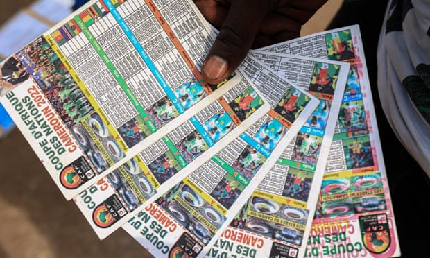 A vendor holds schedules for the Africa Cup of Nations in Yaoundé, the capital of Cameroon