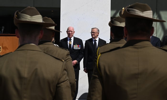 A view over the shoulders of military personnel of David Hurley and Anthony Albanese standing next to each other on the forecourt of Parliament House