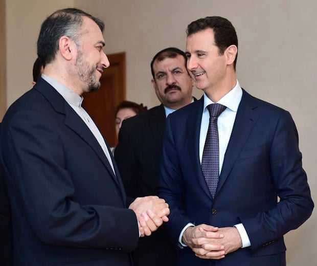 Syrian President Bashar Assad, right, speaks with Iran’s Deputy Foreign Minister Hossein Amir Abdollahian, left, in Damascus, Syria, in 2015.