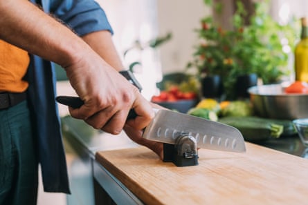 Image of a knife being sharpened with a pull-through sharpener
