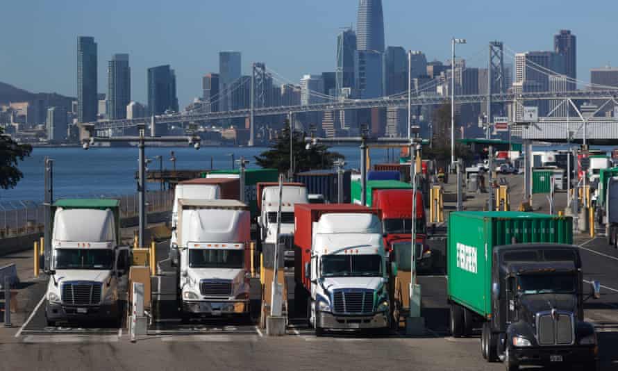 Trucks hauling shipping containers leave the EverPort terminal at the Port of Oakland in Oakland, California.