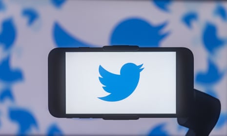 Twitter logo is displayed on a mobile phone screen.